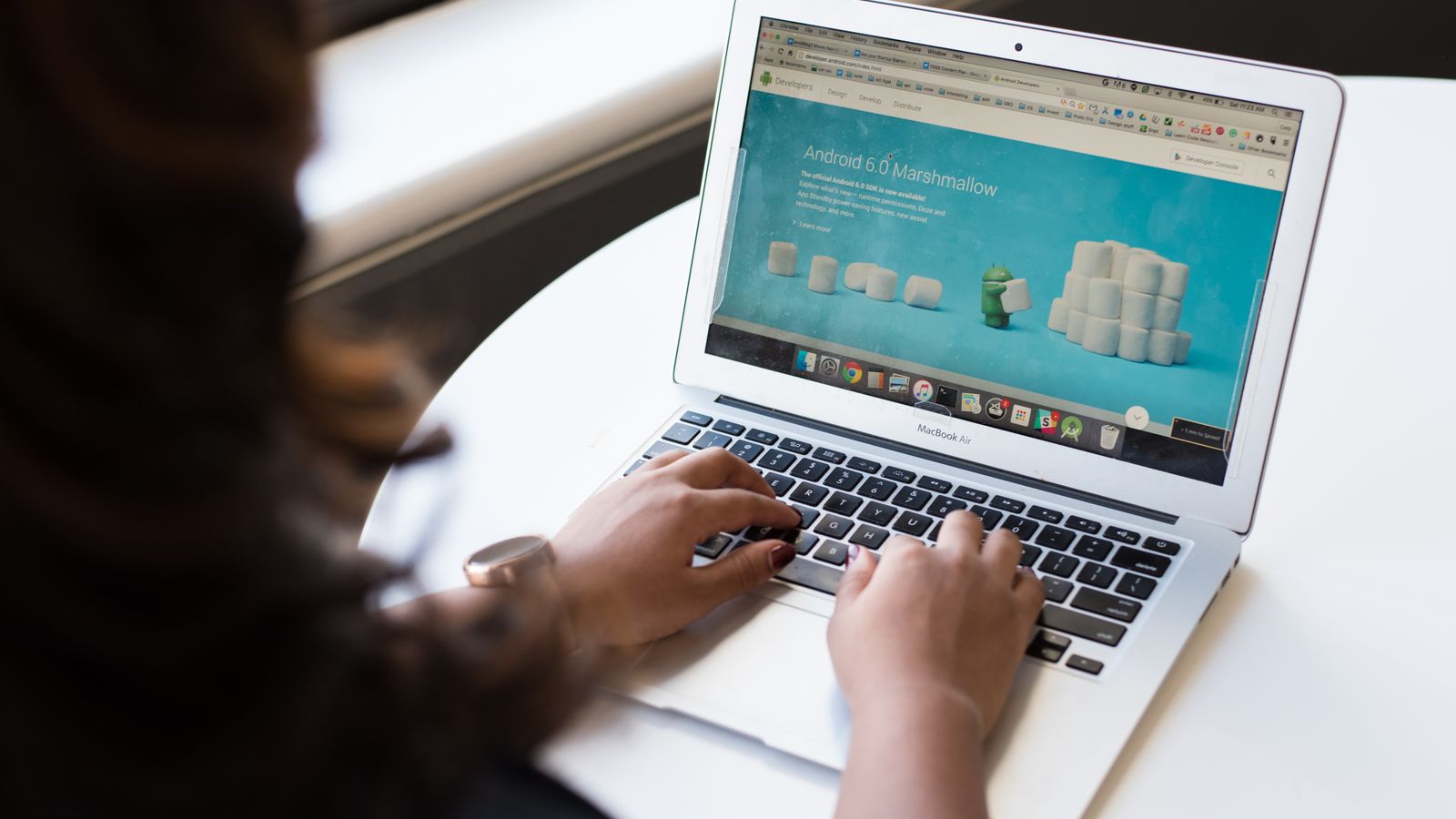 Small-business owner reading a website enquiry that still has to be copied into a CRM by hand